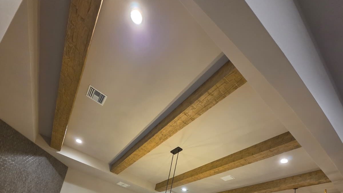 Finish carpentry work in an Orlando home, wood ceiling beams installed and trimmed
